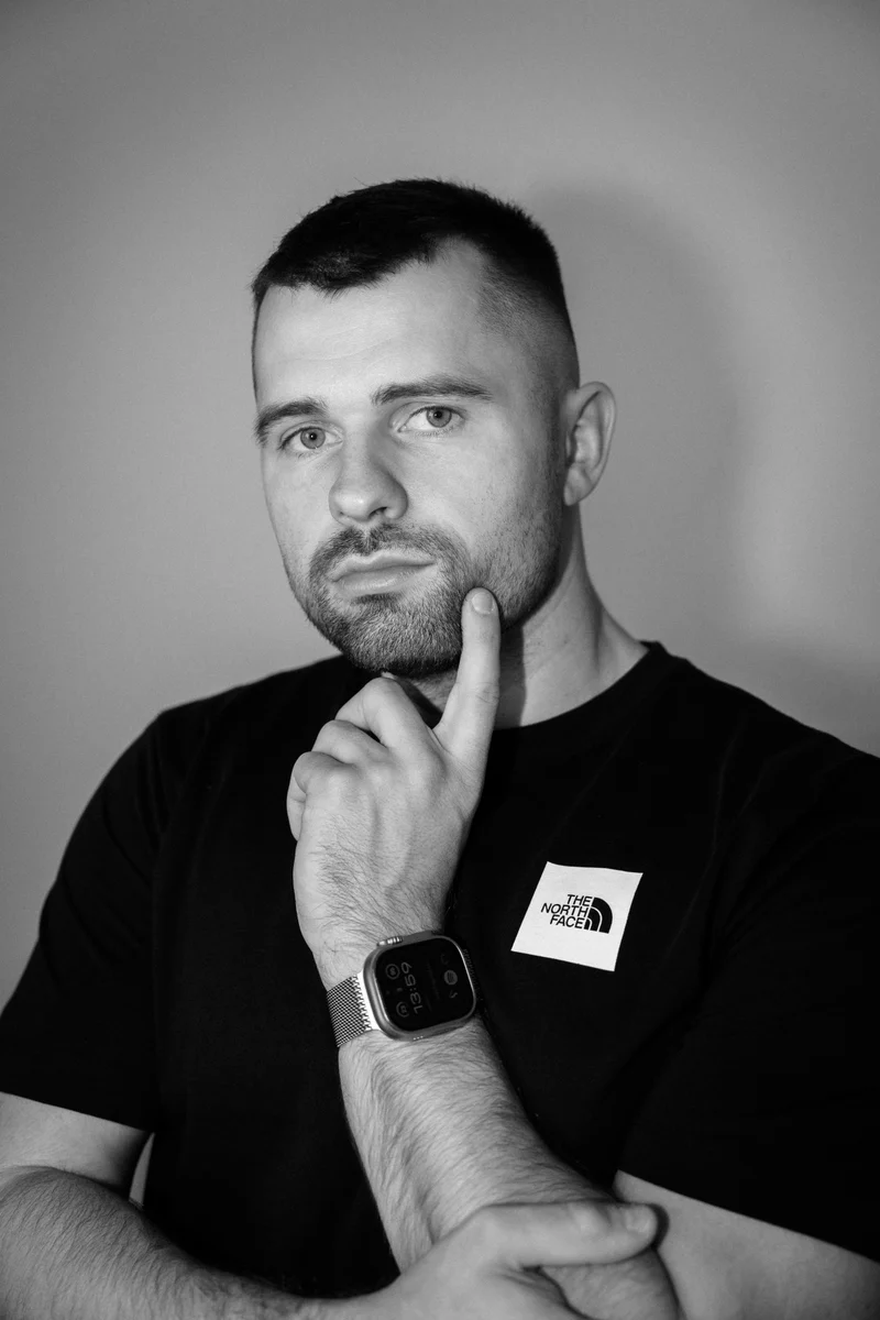 Portrait of Lukáš Granatier looking at the camera with his hand at his chin
