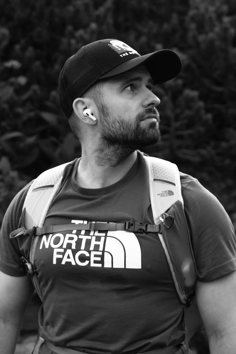 Lukáš Granatier in a cap with a pack, on a mountain trail