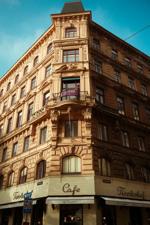 A historic corner building in warm light beneath a blue sky